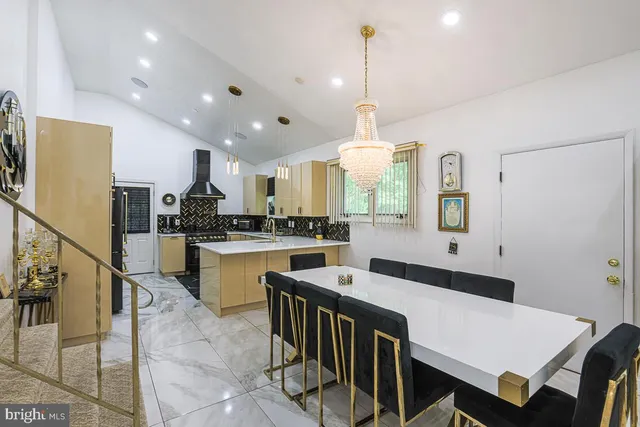 a kitchen with kitchen island granite countertop a sink a center island stainless steel appliances and cabinets