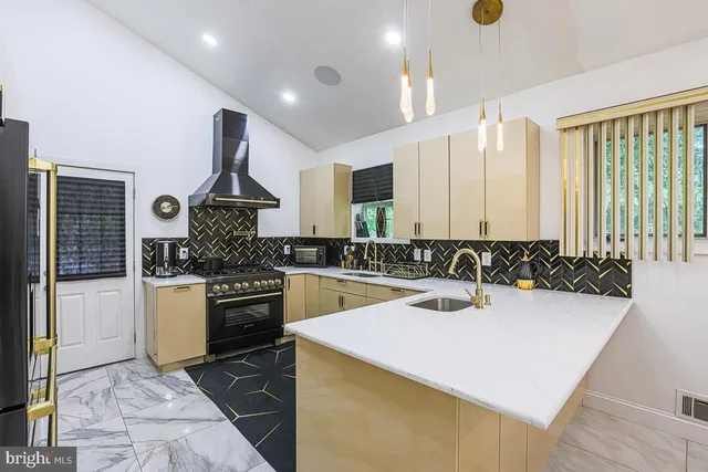 a kitchen with a sink a stove and cabinets