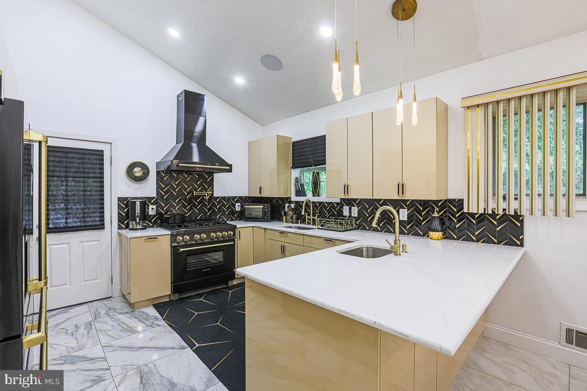 3111 Parkington Avenue Baltimore, MD 21215 - Photo 10 of 47 a kitchen with a sink a stove and cabinets