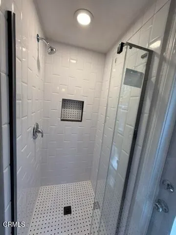 a bathroom with a shower and a toilet