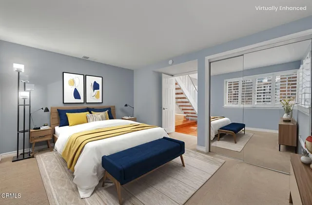 a bedroom with a bed and a couch