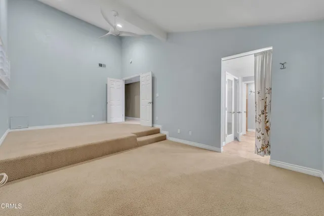 a view of an empty room and closet area