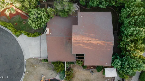 an aerial view of a house with yard and garden