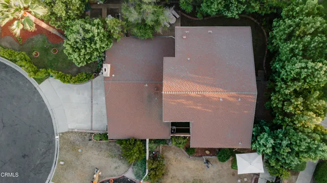 an aerial view of a house with yard and garden