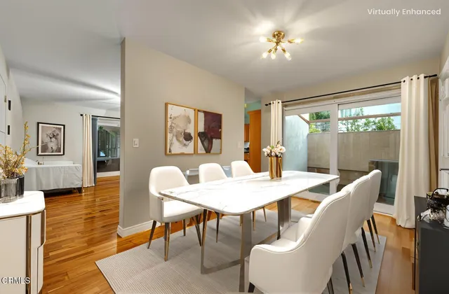 a view of a dining room with furniture window and wooden floor