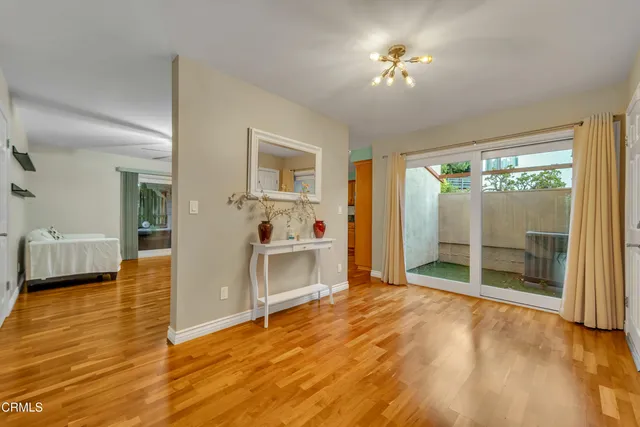 a view of a livingroom with furniture hardwood floor and a ceiling fan