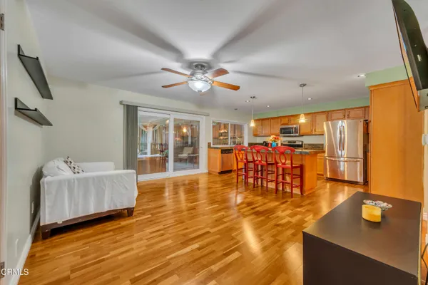 a living room with furniture and wooden floor