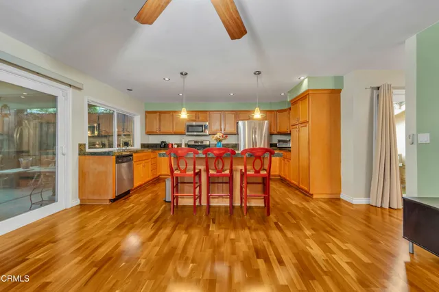 a view of a kitchen with dining space and wooden floor