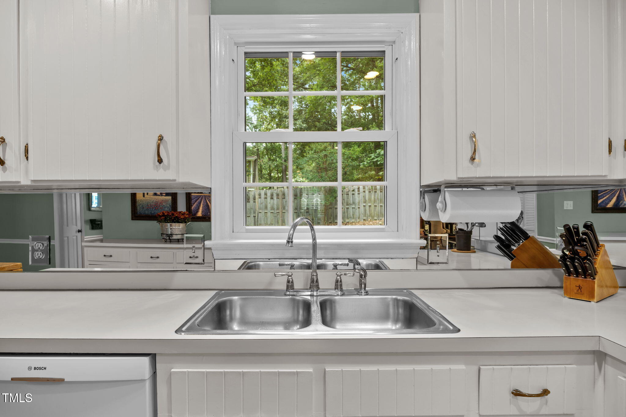 8009 Running Cedar Trail Raleigh, NC 27615 - Photo 11 of 42 a kitchen sink with a microwave and cabinets