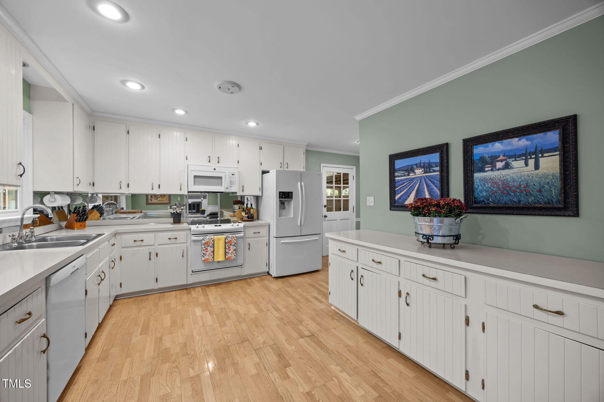 8009 Running Cedar Trail Raleigh, NC 27615 - Photo 13 of 42 a kitchen with cabinets and wooden floor