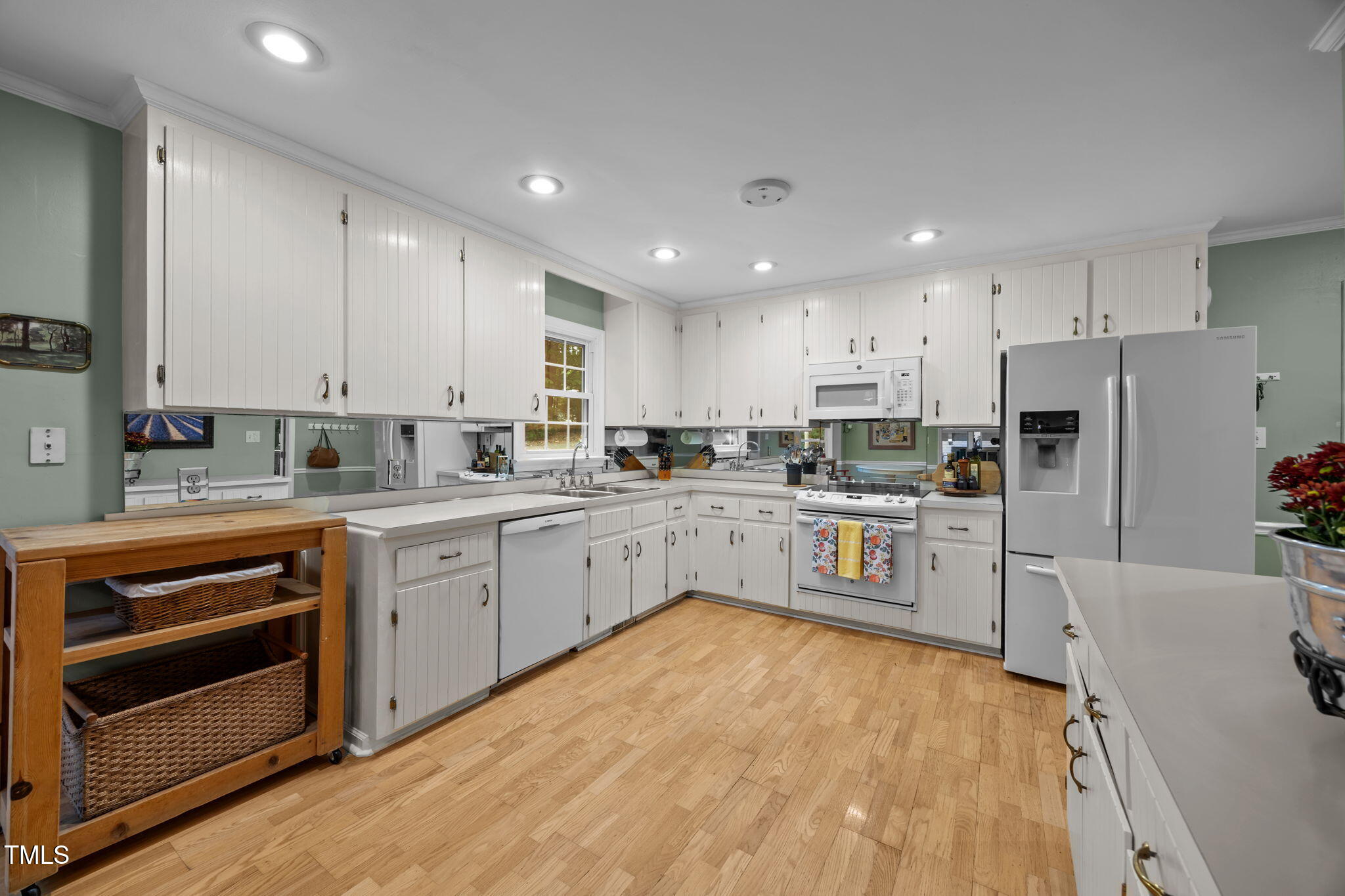 8009 Running Cedar Trail Raleigh, NC 27615 - Photo 14 of 42 a kitchen with white cabinets and stainless steel appliances