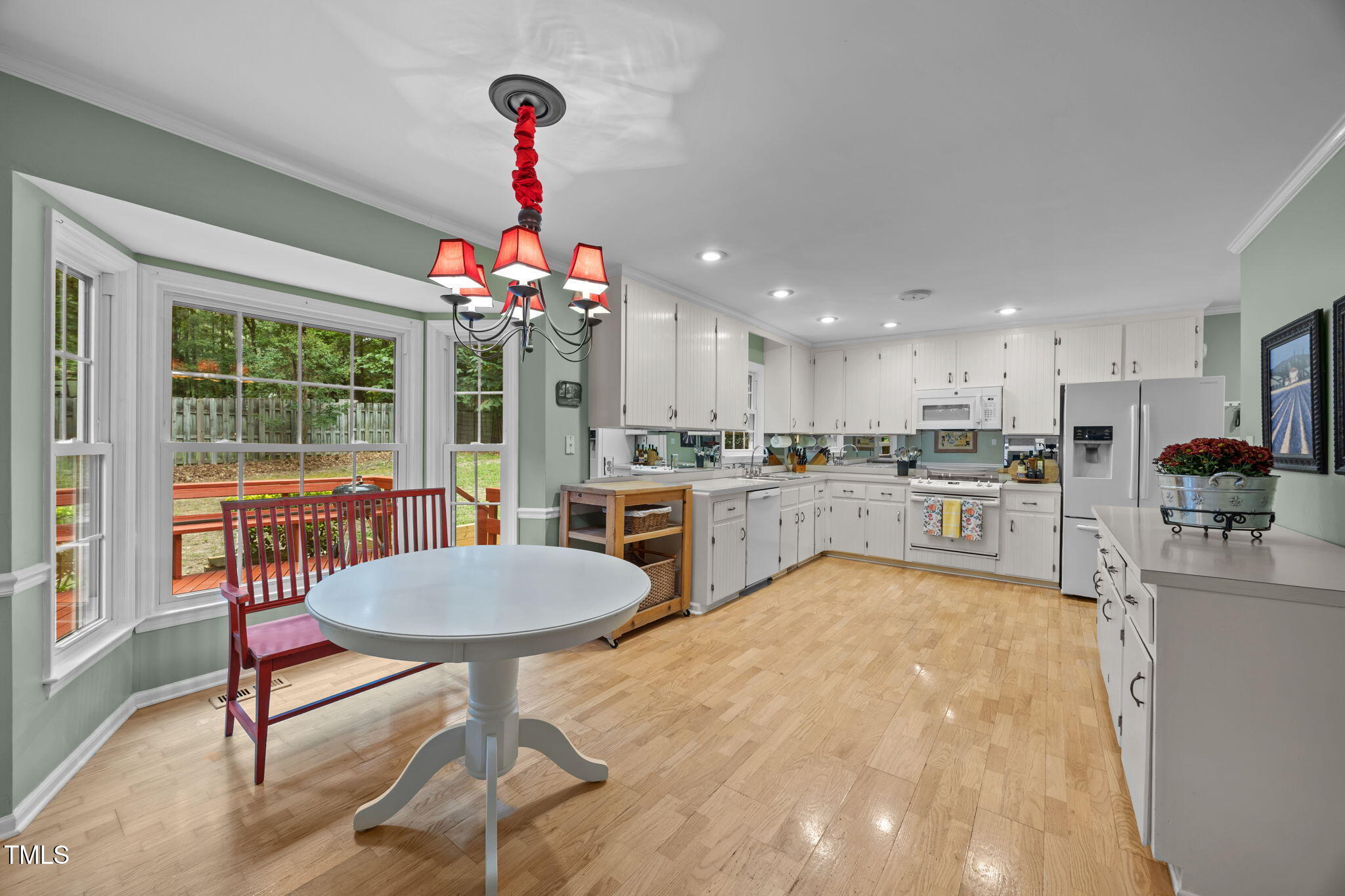 8009 Running Cedar Trail Raleigh, NC 27615 - Photo 15 of 42 a living room with dining room and a chandelier