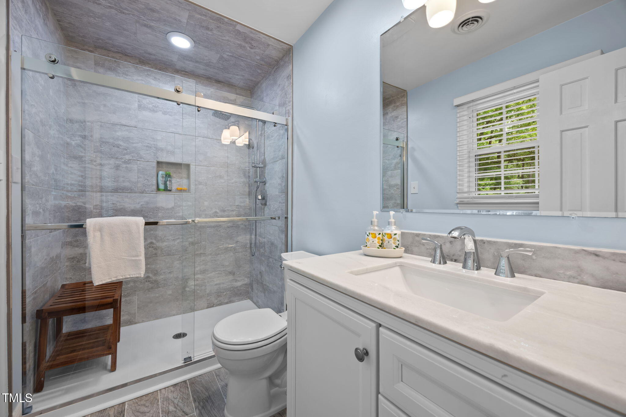 8009 Running Cedar Trail Raleigh, NC 27615 - Photo 22 of 42 a bathroom with a sink a toilet and shower