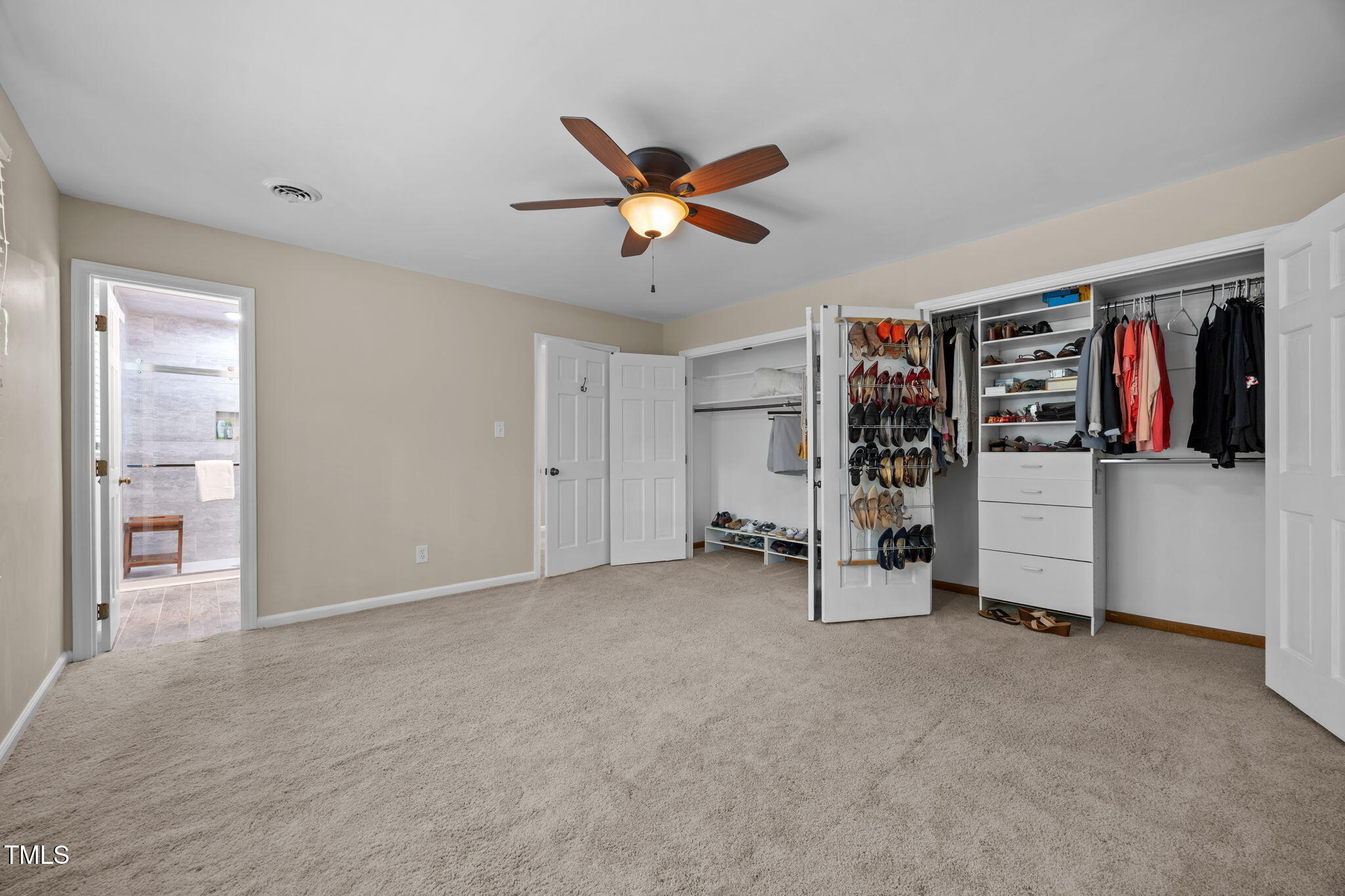 8009 Running Cedar Trail Raleigh, NC 27615 - Photo 23 of 42 a view of a livingroom with a ceiling fan & entryway closet