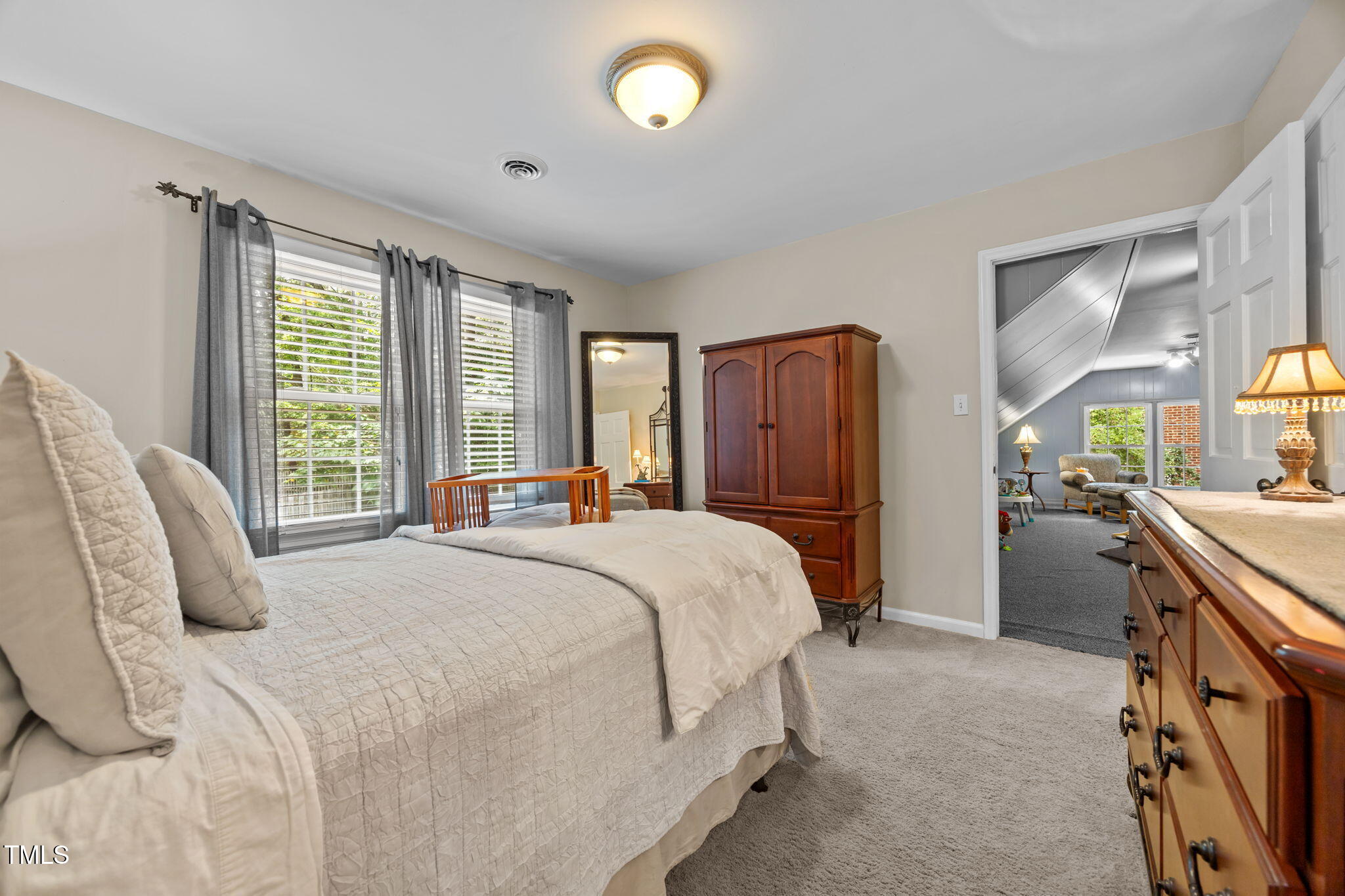 8009 Running Cedar Trail Raleigh, NC 27615 - Photo 24 of 42 a bedroom with a bed and a dresser with mirror