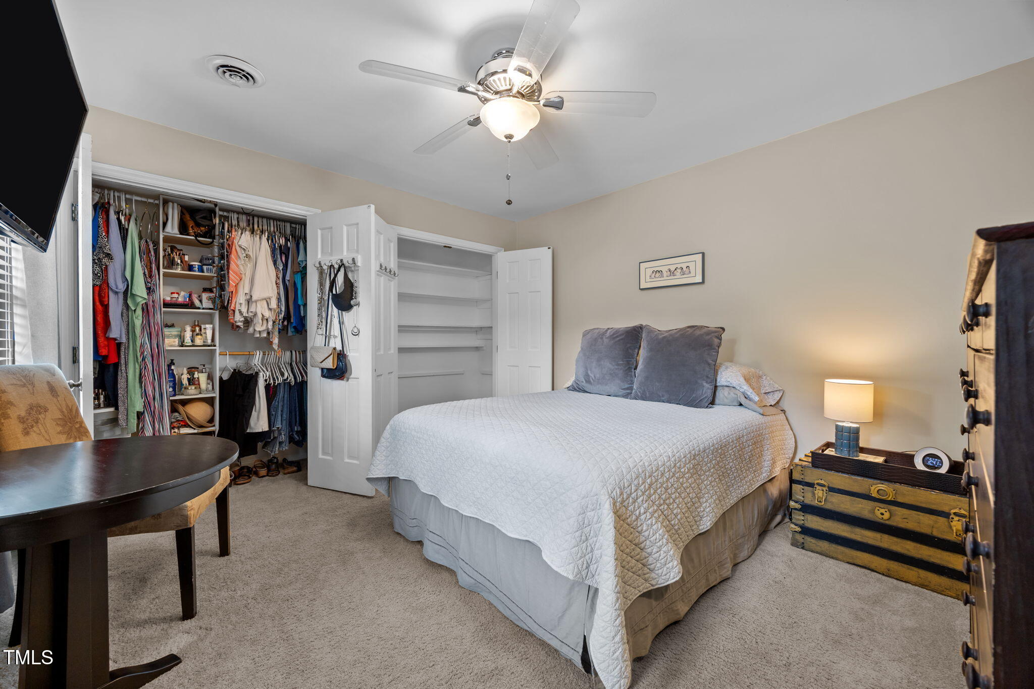 8009 Running Cedar Trail Raleigh, NC 27615 - Photo 29 of 42 a bedroom with a bed and a chandelier