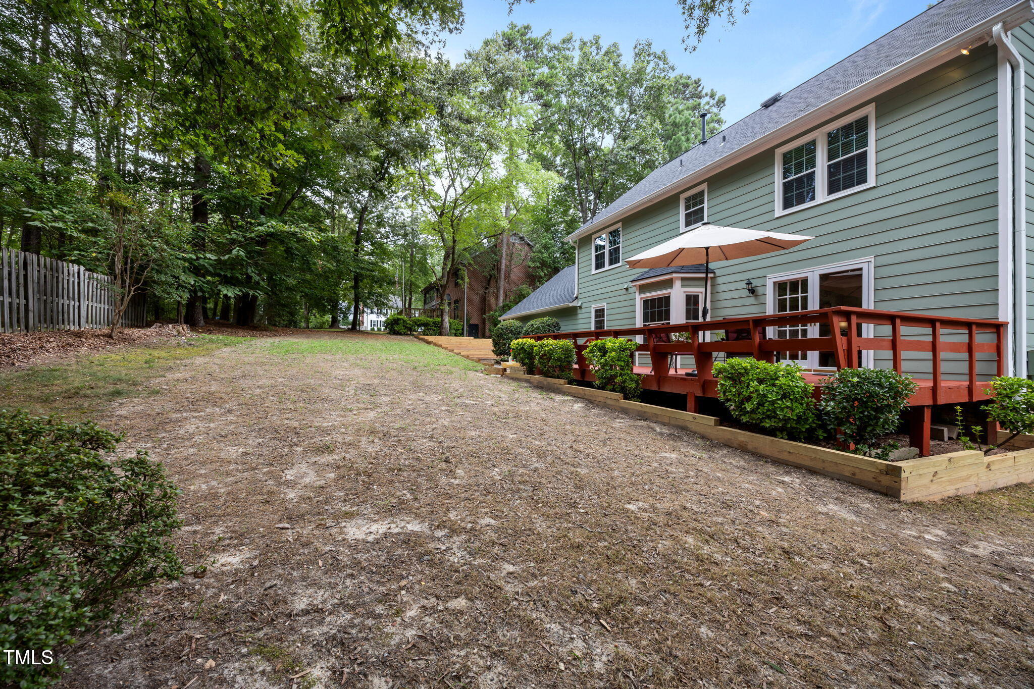 8009 Running Cedar Trail Raleigh, NC 27615 - Photo 36 of 42 a front view of a house with a yard and potted plants