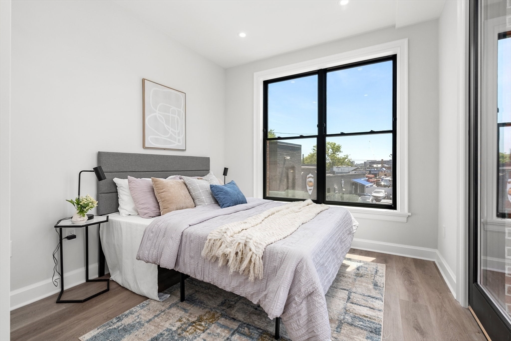 523 2nd Street, Unit 303 Everett, MA 02149 - Photo 9 of 11 a bedroom with a large bed and a large window