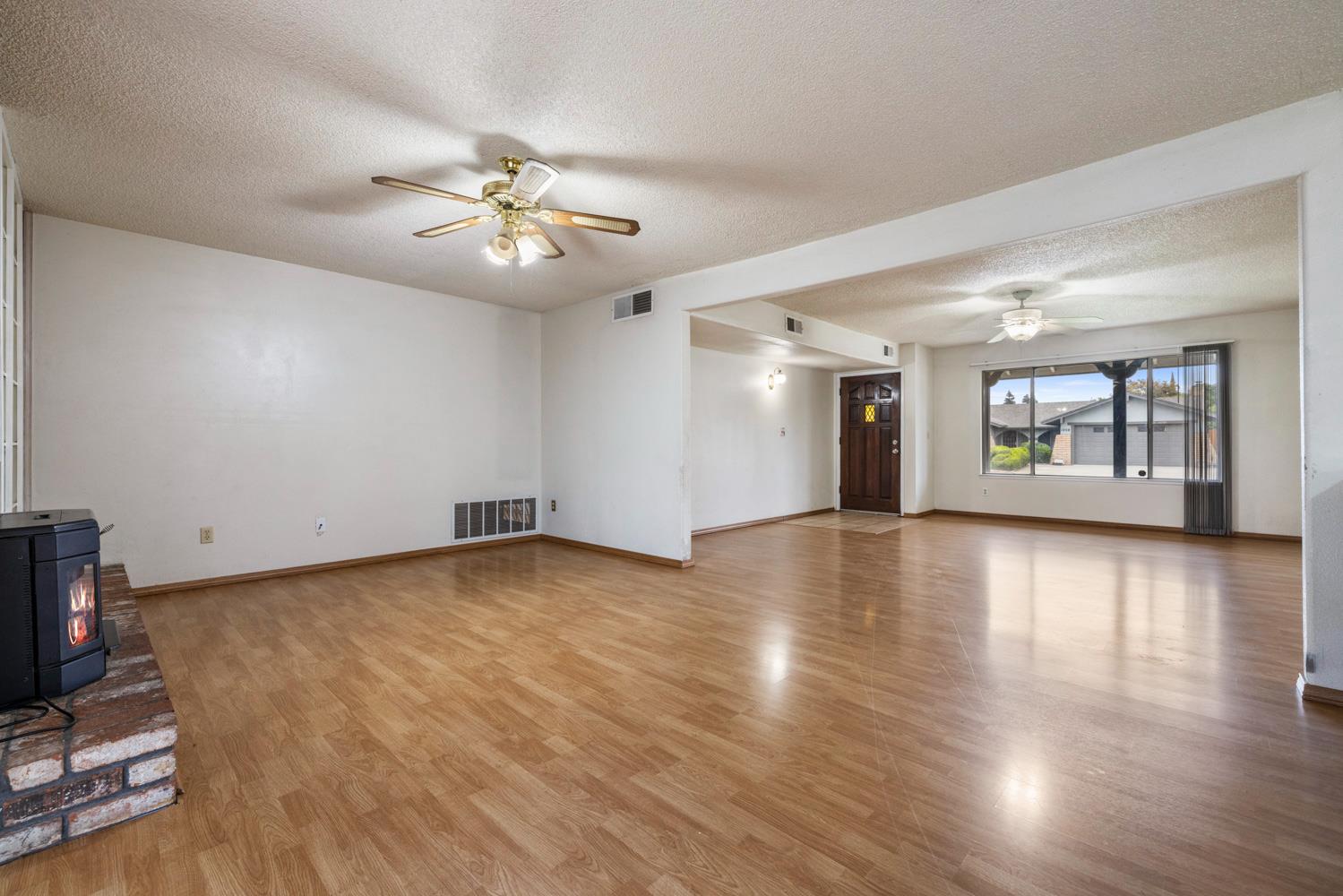 1205 Kara Lane Modesto, CA 95355 - Photo 12 of 39 a view of an empty room with window and wooden floor