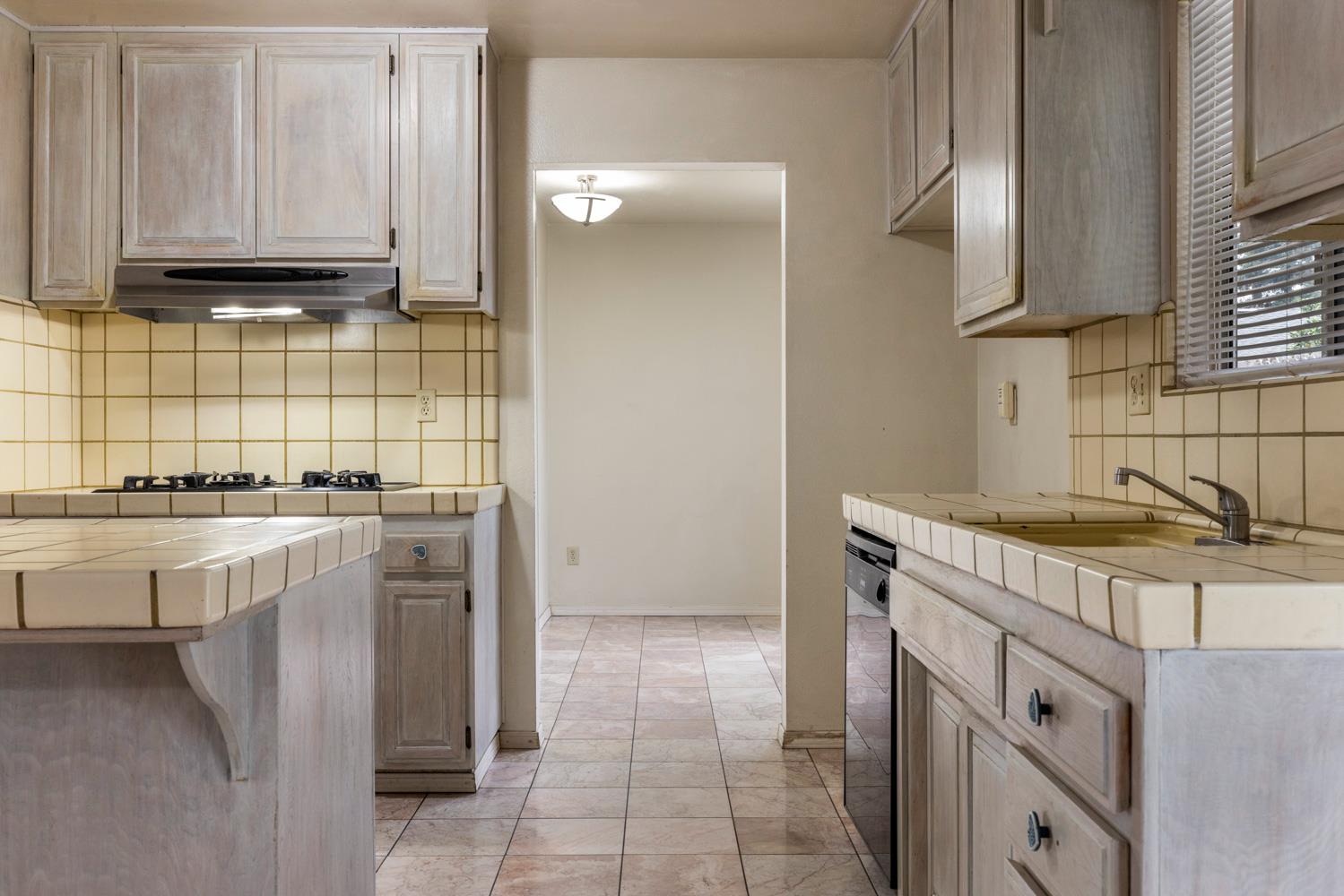 1205 Kara Lane Modesto, CA 95355 - Photo 14 of 39 a kitchen with a sink and cabinets