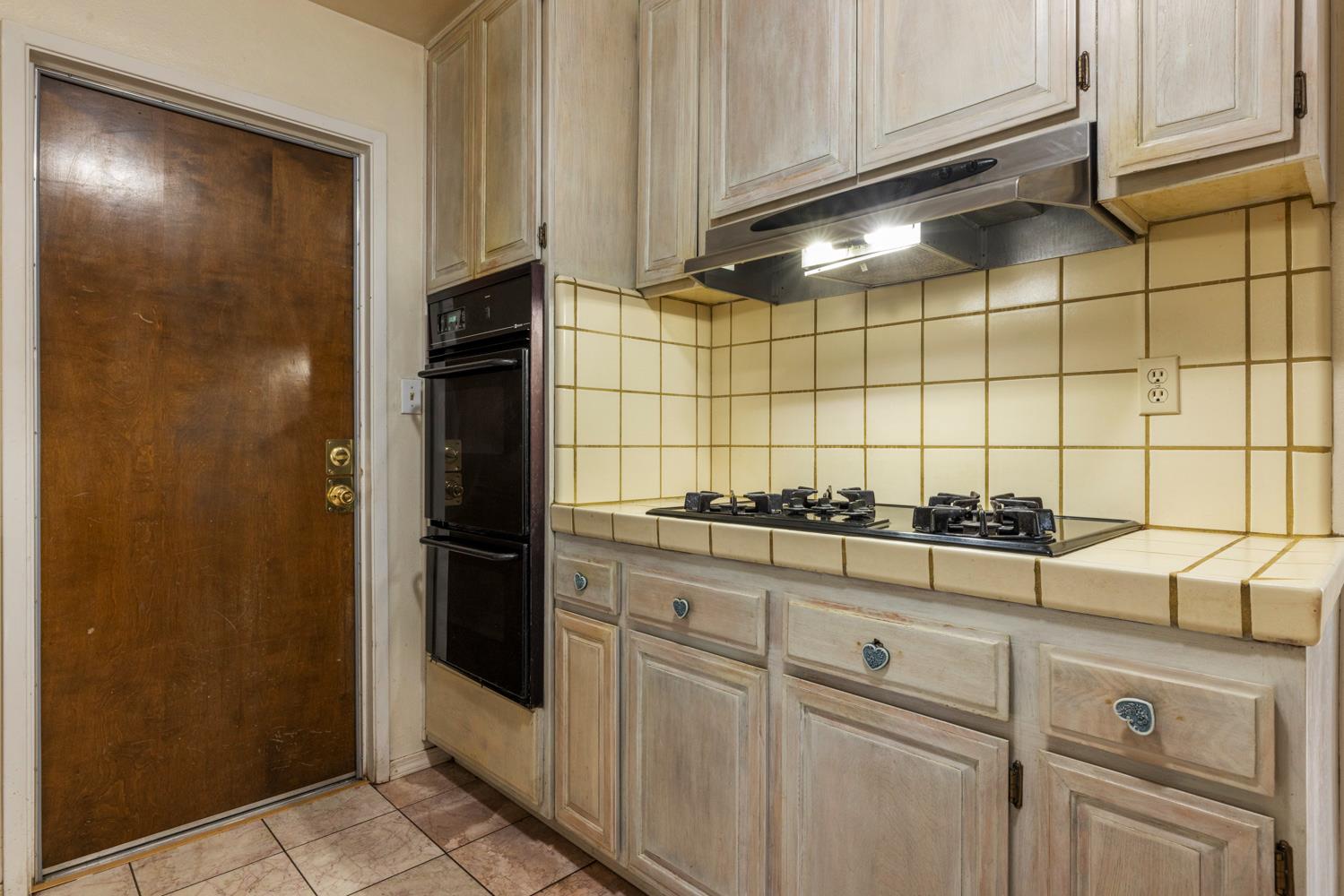 1205 Kara Lane Modesto, CA 95355 - Photo 15 of 39 a kitchen with granite countertop white cabinets and stainless steel appliances