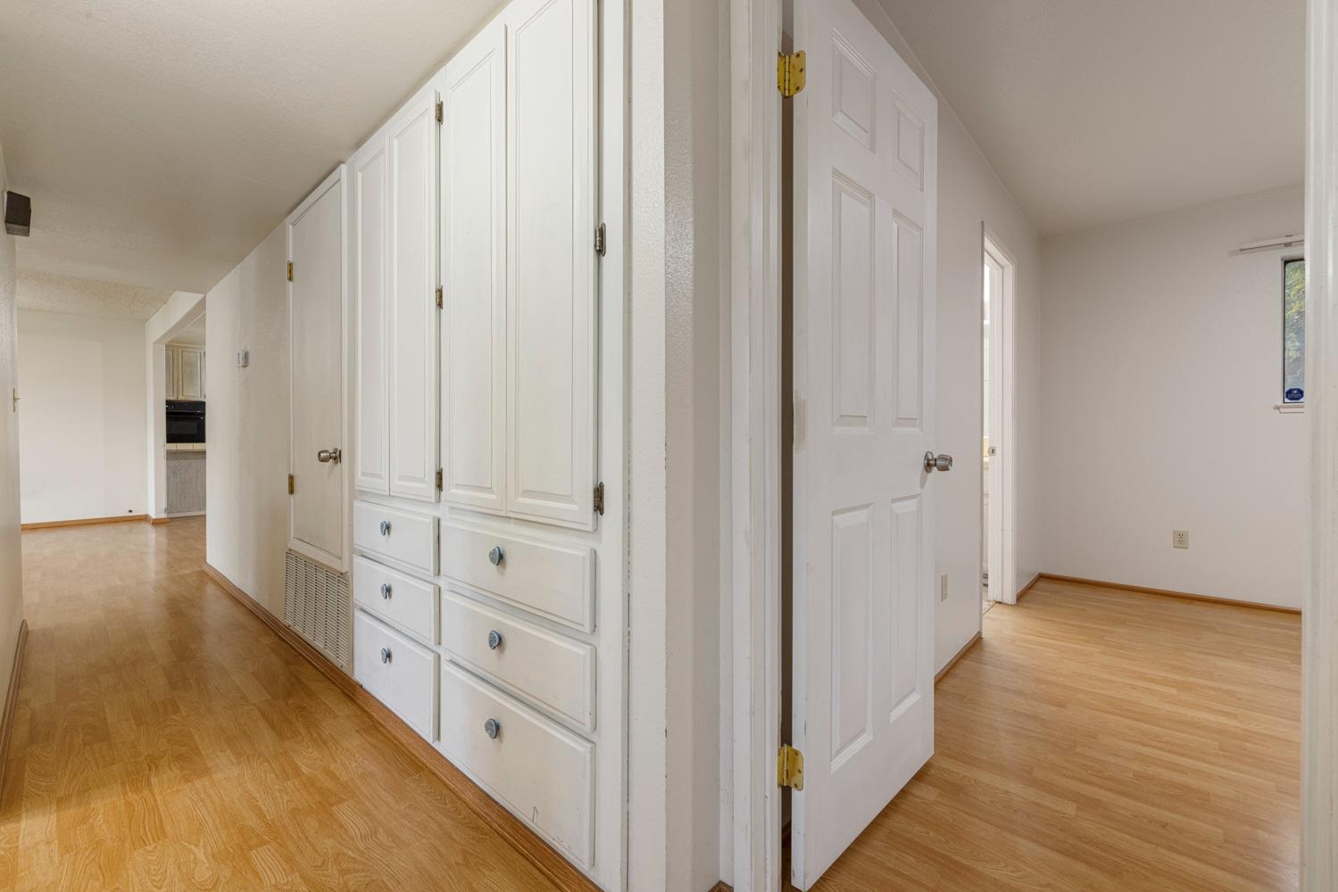 1205 Kara Lane Modesto, CA 95355 - Photo 24 of 39 a view of a hallway with wooden floor