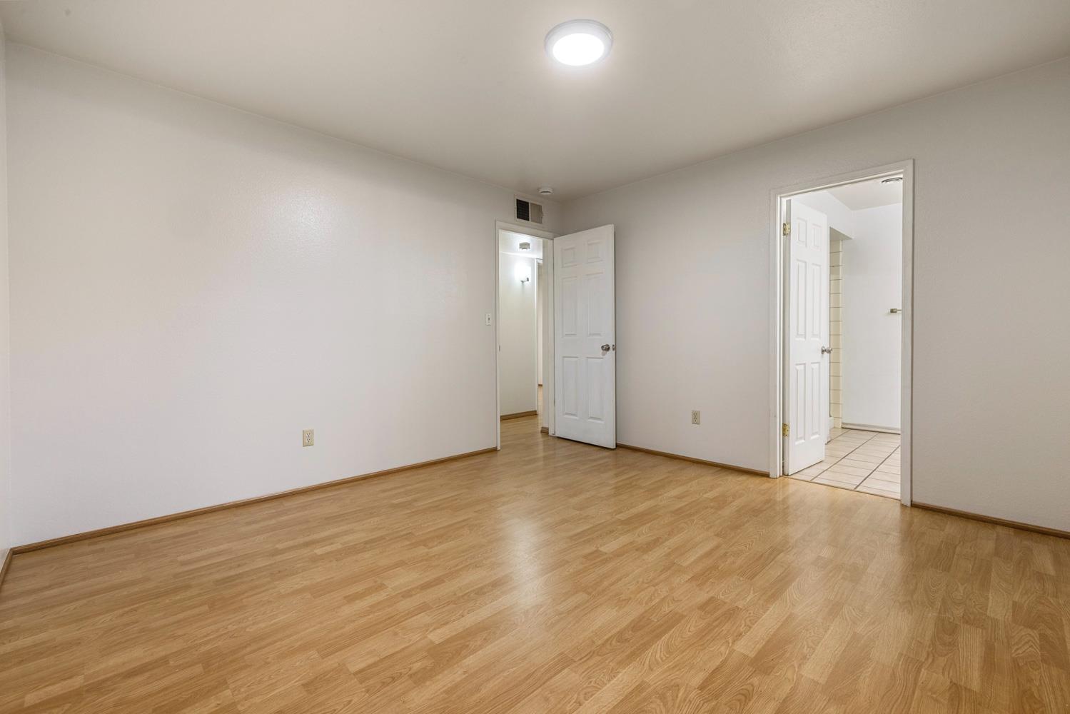 1205 Kara Lane Modesto, CA 95355 - Photo 26 of 39 a view of an empty room and wooden floor