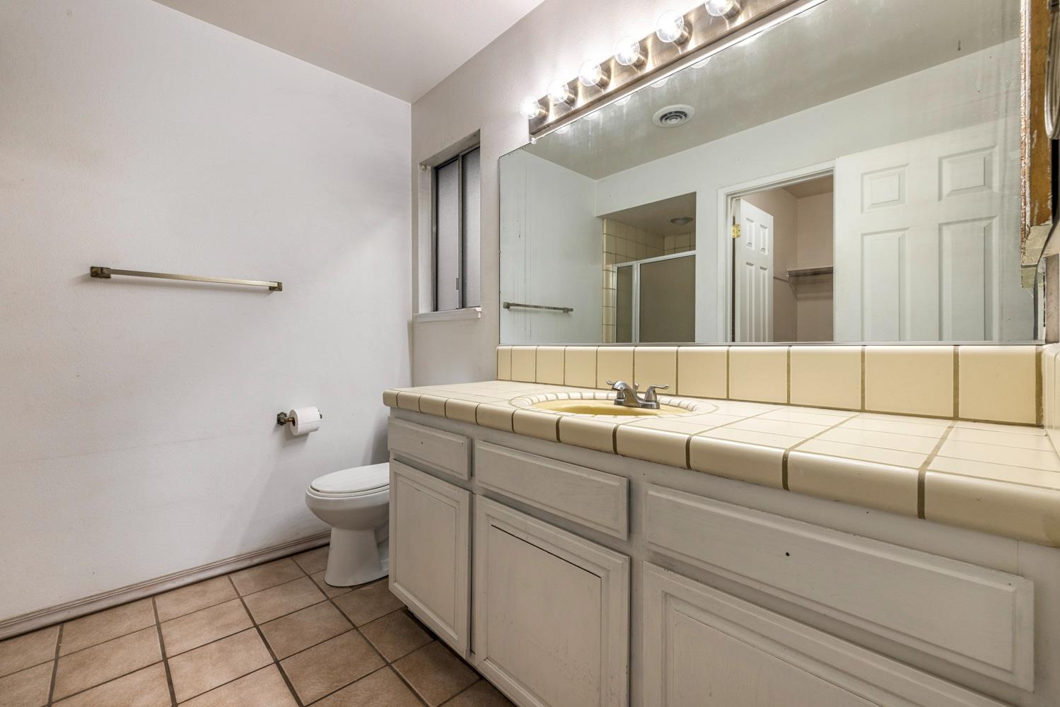 1205 Kara Lane Modesto, CA 95355 - Photo 27 of 39 a bathroom with a toilet sink and mirror
