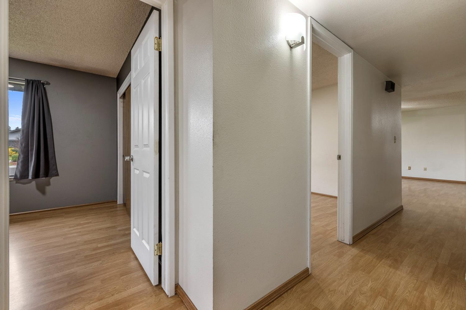 1205 Kara Lane Modesto, CA 95355 - Photo 30 of 39 a view of a hallway with wooden floor