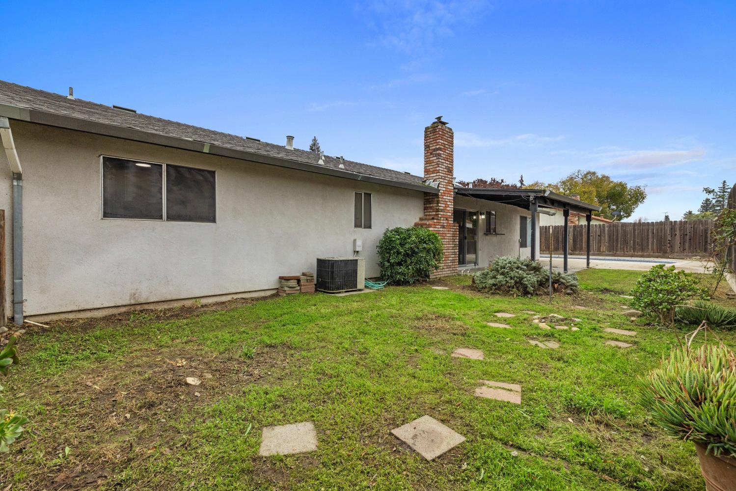 1205 Kara Lane Modesto, CA 95355 - Photo 39 of 39 a backyard of a house with plants and wooden fence