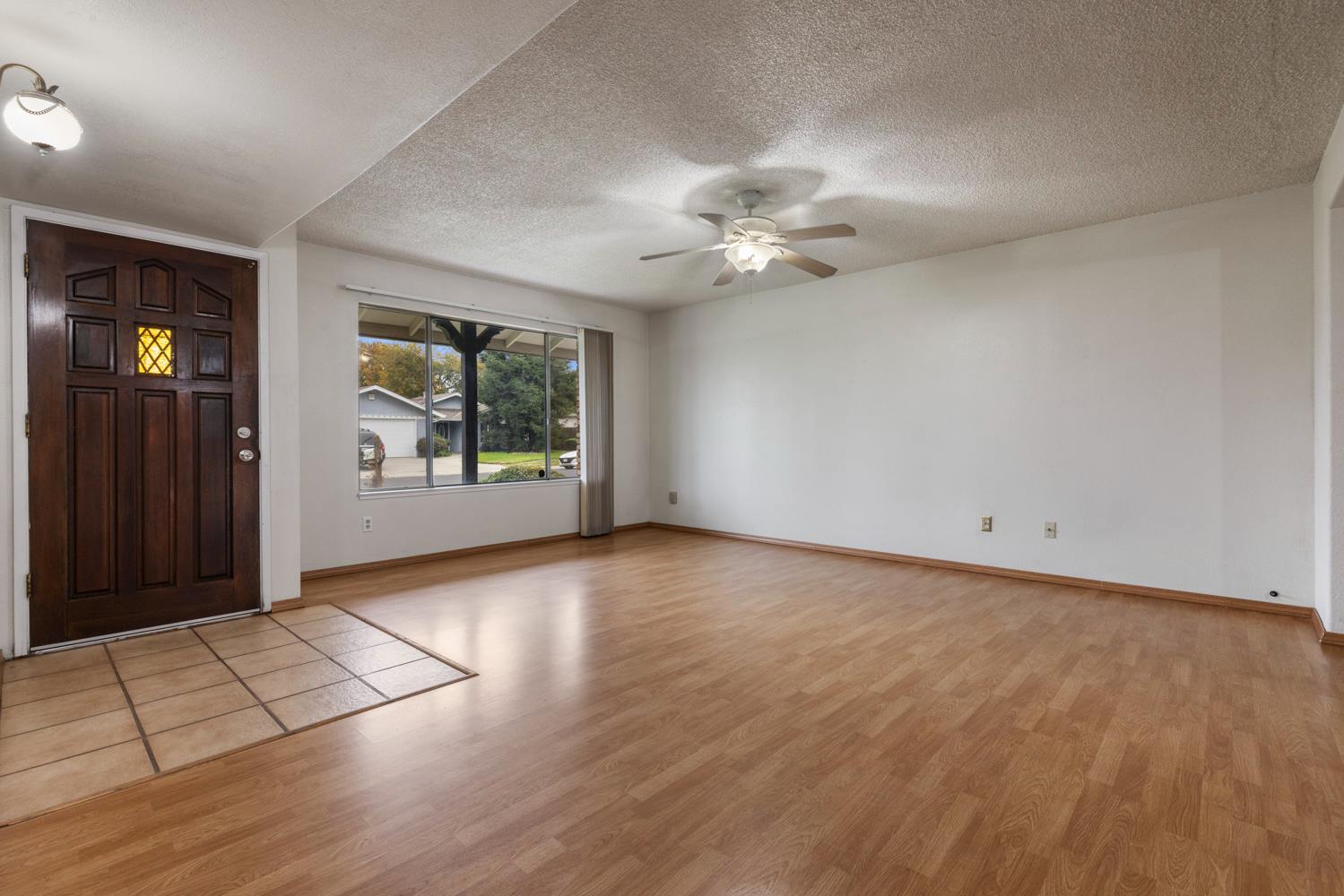 1205 Kara Lane Modesto, CA 95355 - Photo 7 of 39 wooden floor in an empty room with a window