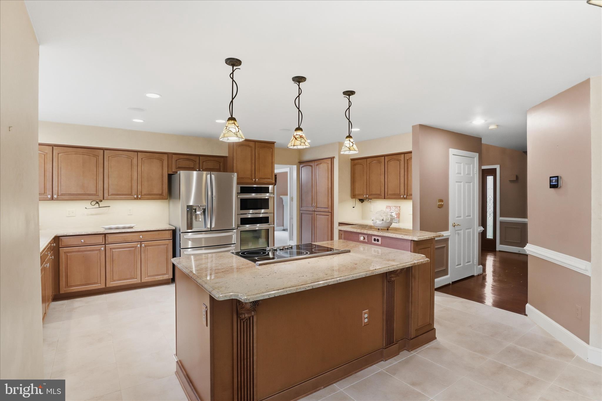 6809 Spout Lane Fairfax Station, VA 22039 - Photo 11 of 81 a kitchen with stainless steel appliances granite countertop a sink a stove and a refrigerator