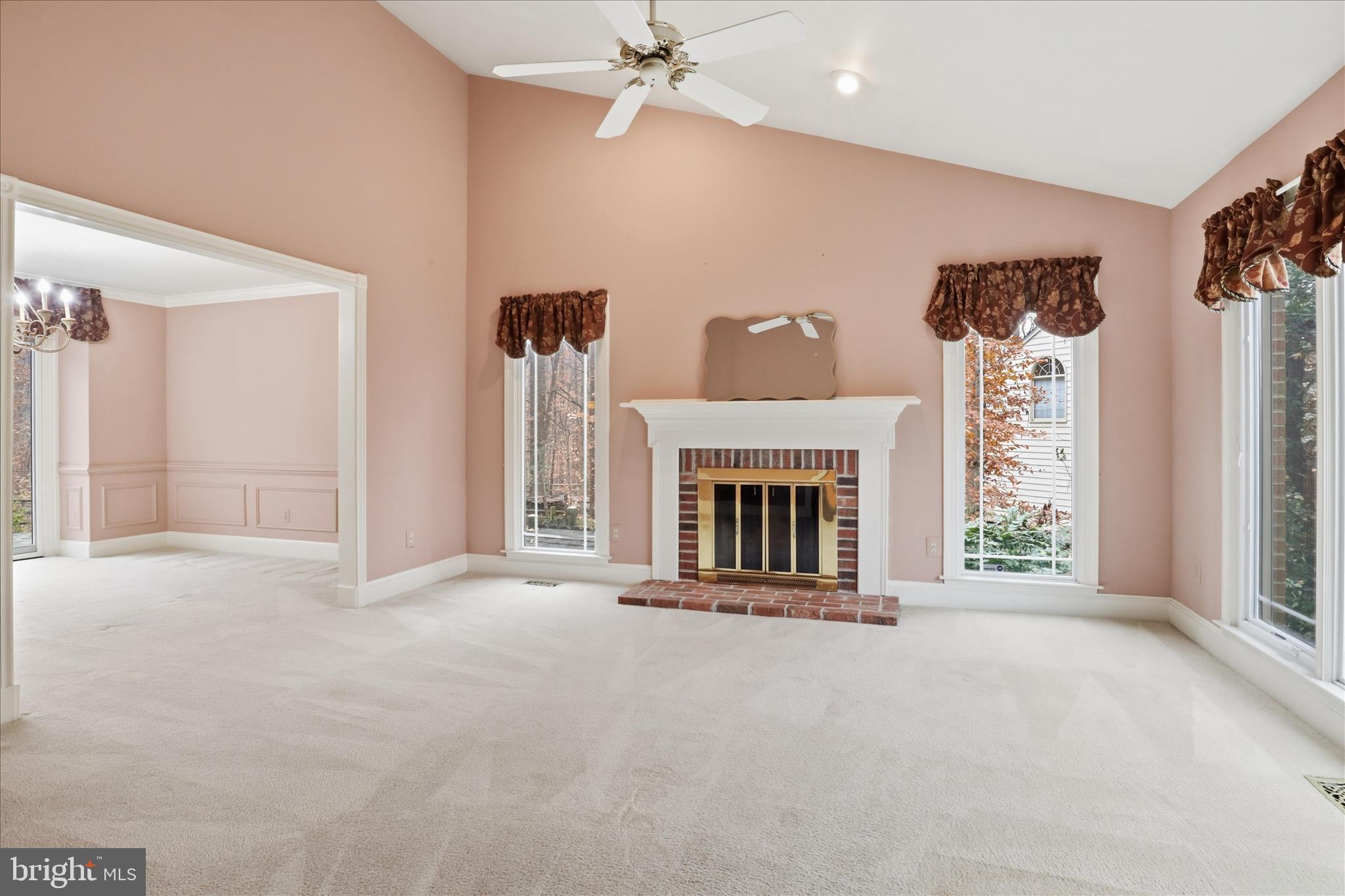 6809 Spout Lane Fairfax Station, VA 22039 - Photo 20 of 81 a view of an empty room with a fireplace and a window