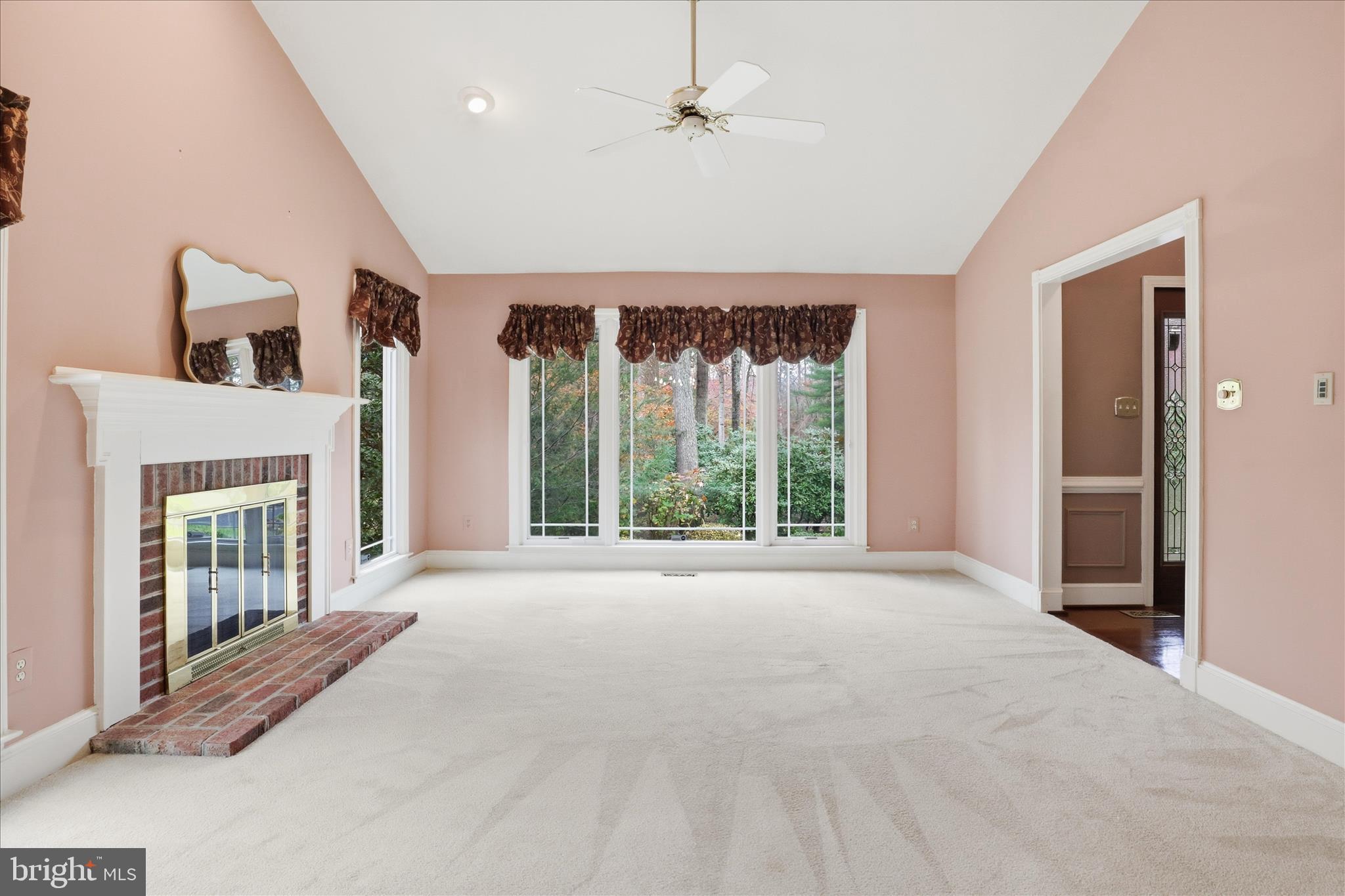 6809 Spout Lane Fairfax Station, VA 22039 - Photo 21 of 81 a view of an empty room with a fireplace and a large window