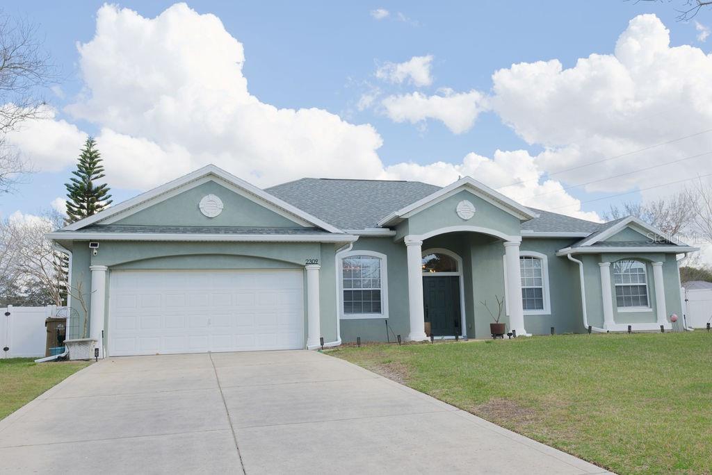 2309 Wolf Ridge Lane Mount Dora, FL 32757 - Photo 1 of 62 a front view of a house with garden