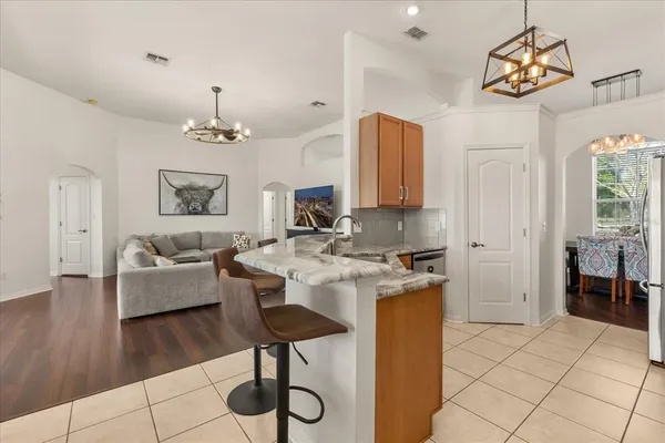 a living room with furniture and a chandelier