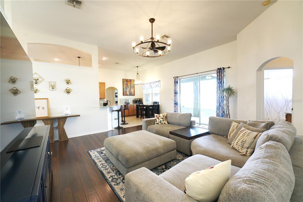 2309 Wolf Ridge Lane Mount Dora, FL 32757 - Photo 14 of 62 a living room with furniture kitchen view and a chandelier
