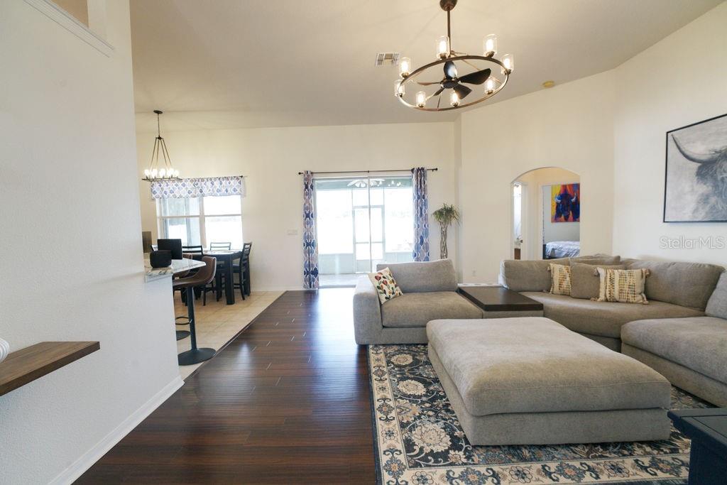 2309 Wolf Ridge Lane Mount Dora, FL 32757 - Photo 15 of 62 a living room with furniture and a chandelier