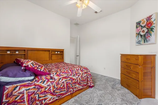 a bedroom with a bed and dresser