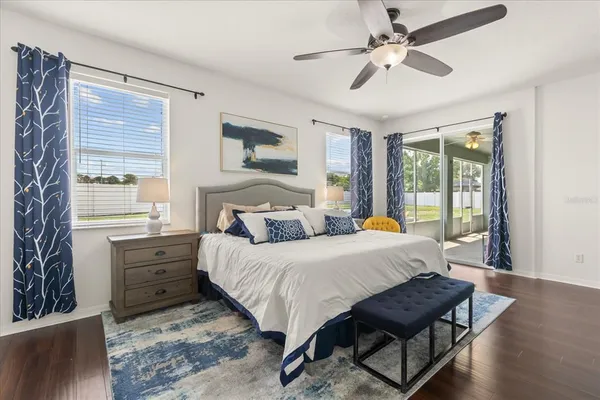 a bedroom with a bed a chandelier and a window