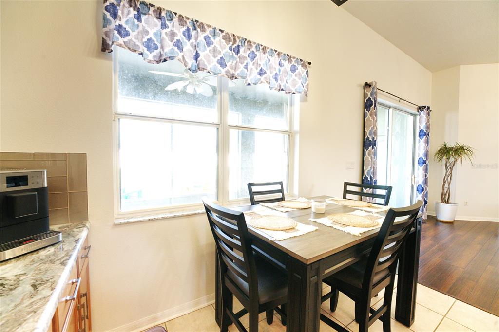 2309 Wolf Ridge Lane Mount Dora, FL 32757 - Photo 24 of 62 a view of a dining table and chairs in a room