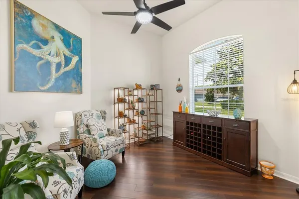 a living room with furniture and a large window with wooden floor