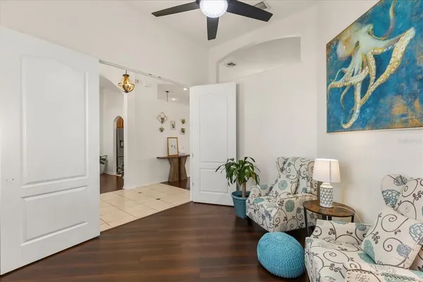 a living room with furniture and a chandelier