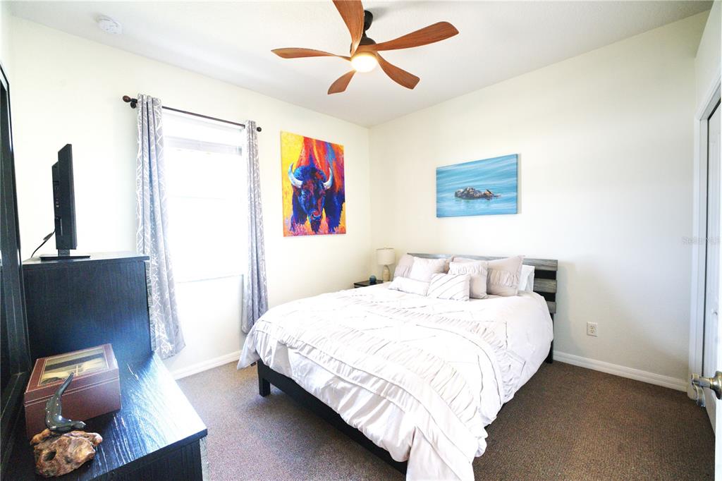 2309 Wolf Ridge Lane Mount Dora, FL 32757 - Photo 26 of 62 a bedroom with a bed and cabinets