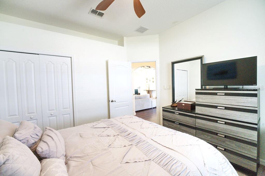 2309 Wolf Ridge Lane Mount Dora, FL 32757 - Photo 27 of 62 a bedroom with a bed and a flat screen tv
