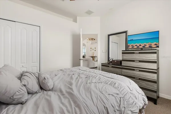 a bedroom with a bed and a flat tv screen