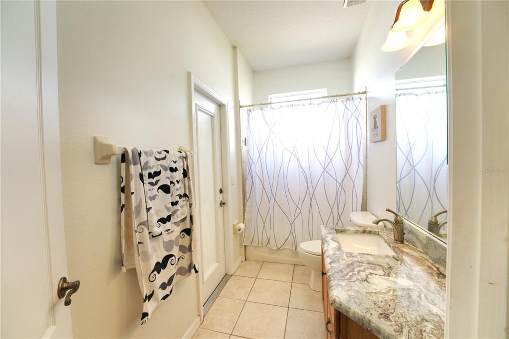 2309 Wolf Ridge Lane Mount Dora, FL 32757 - Photo 29 of 62 a bathroom with a shower curtain and a window