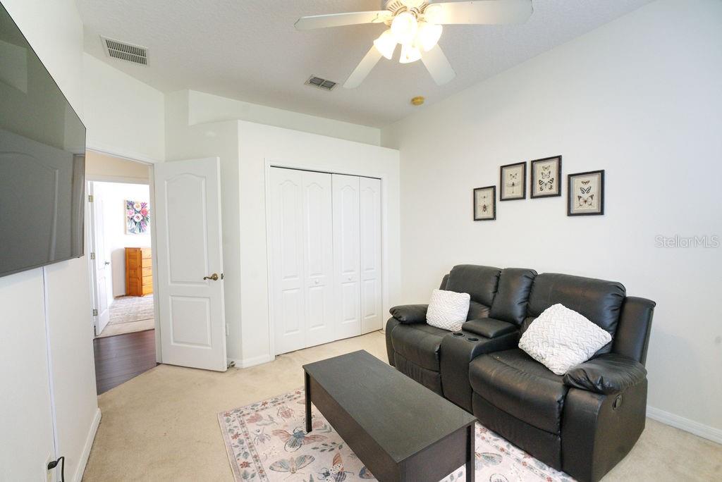 2309 Wolf Ridge Lane Mount Dora, FL 32757 - Photo 34 of 62 a living room with furniture and a chandelier