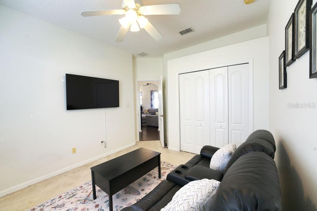 2309 Wolf Ridge Lane Mount Dora, FL 32757 - Photo 35 of 62 a living room with furniture a flat screen tv and a ceiling fan