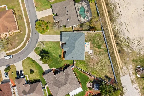 an aerial view of a house with a yard